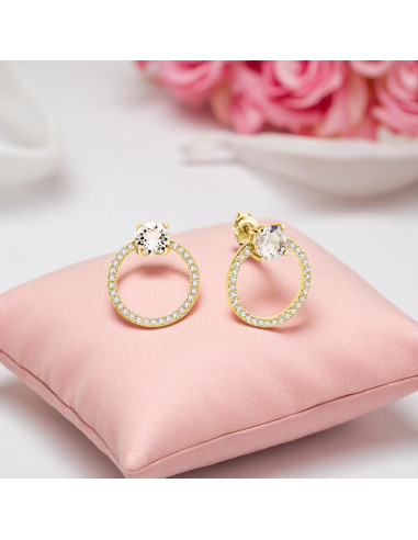 STARDUST SPARK gold-plated earrings with white Swarovski® crystals on colored background