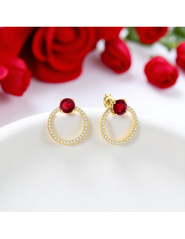 STARDUST SPARK gold-plated earrings with red Swarovski® crystals on colored background